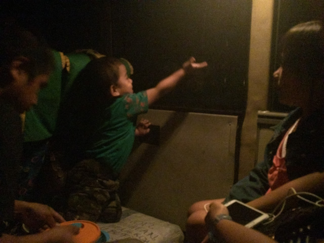 child on bus shows us it's beginning to rain inside