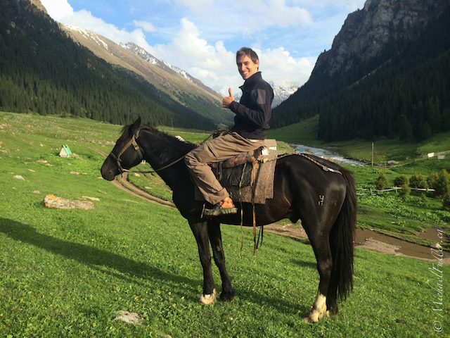 Myke on a horse in Kyrgyzstan