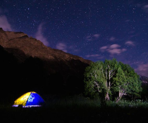 Camping at a river delta in the Pamir Mountains, inside a leaky $20 tent we named 'Oliver'.