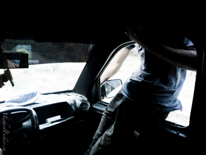 tajik man climbing onto car